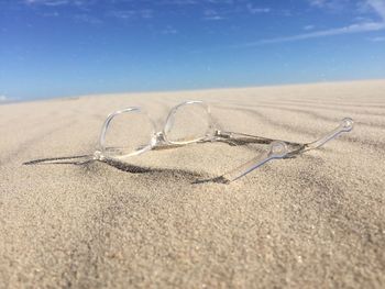 Clear glasses on sand at beach