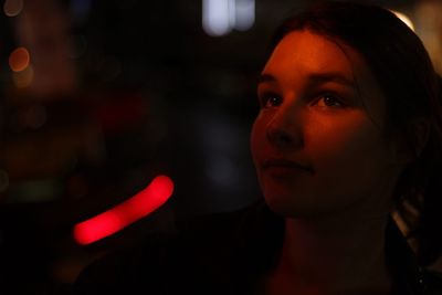 Close-up of young woman looking up