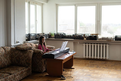 Girl playing piano at home