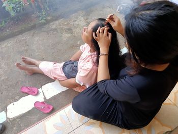 High angle view of women sitting on floor