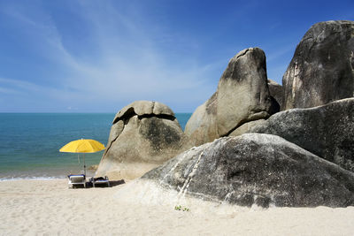 Panoramic view of rocks on beach against sky