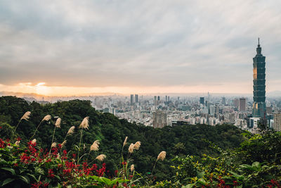 Panoramic view of buildings against cloudy sky