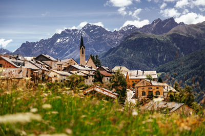 Buildings and mountains against sky