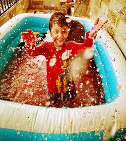 Portrait of smiling boy in swimming pool