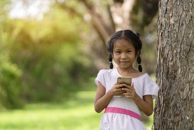 Portrait of cute girl standing outdoors