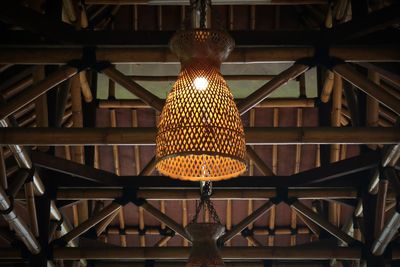 Low angle view of illuminated lamp in building