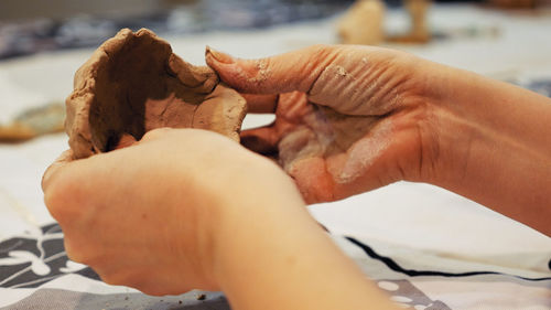 Close-up of woman playing with clay
