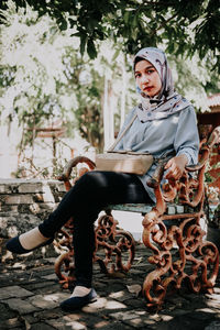 Portrait of woman sitting outdoors