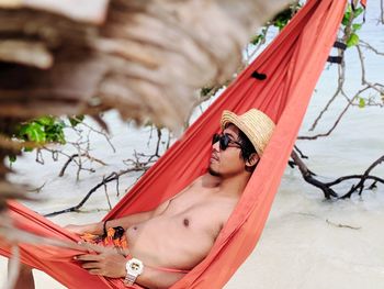 Woman lying down on hammock