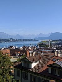 High angle view of townscape by sea against sky