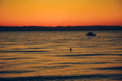 Scenic view of sea against orange sky