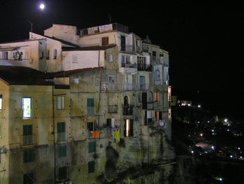 Illuminated town against sky at night