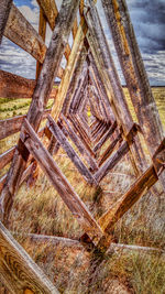 Close-up of wooden post against sky