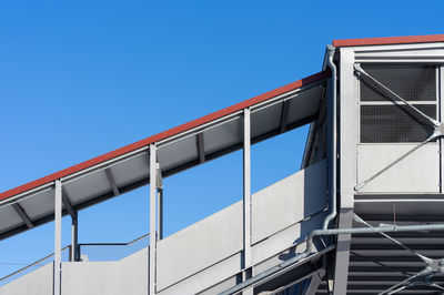 Low angle view of modern building against clear blue sky