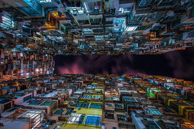 Illuminated buildings against sky at night