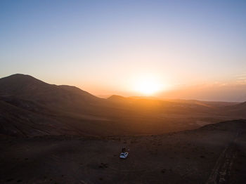 Scenic view of desert against sky during sunset