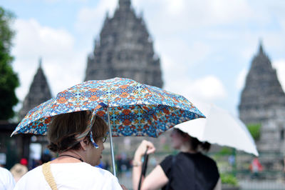 Rear view of people in rain