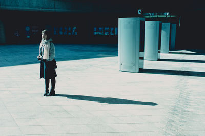 Full length of woman standing by railing