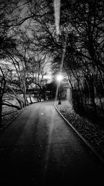 Road amidst trees against sky