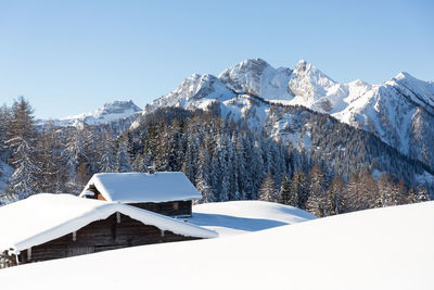 Winter  mountain scenery with snowcapped wooden chalet. austrian alps