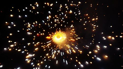 Low angle view of firework display at night