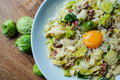 High angle view of food served in plate by cabbage on table