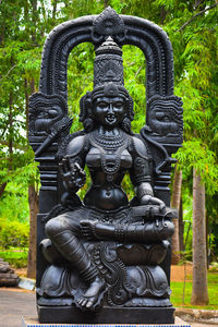Sculpture of buddha statue in temple against building