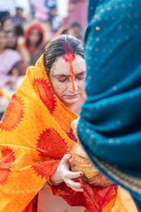 Women devotee with religious offerings for sun god in chhath festival