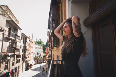 Woman standing by wall