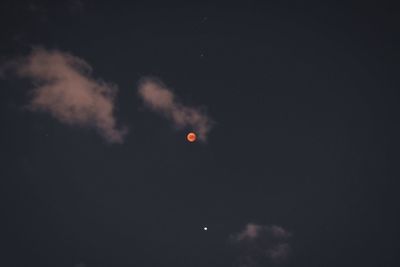 Low angle view of moon against sky at night