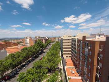 High angle view of street amidst buildings against sky