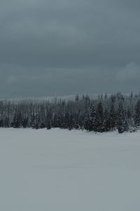 Scenic view of snow covered land against sky