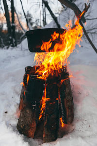 Close-up of container over bonfire during winter