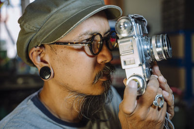 Man repairing camera at workplace