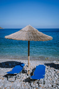 Built structure on beach against clear blue sky