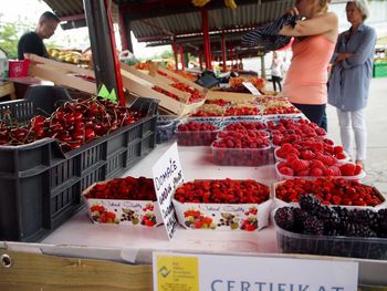 Fresh blackberries and raspberries sold at a french market stall