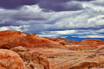 View of rock formations against cloudy sky