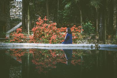 Woman by trees in park