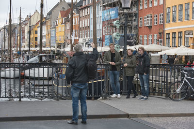 People on street by buildings in city