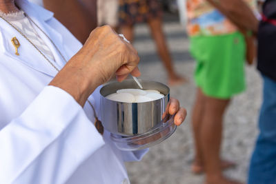Host is distributed by a member of the catholic church during mass at the church of senhor do bonfim