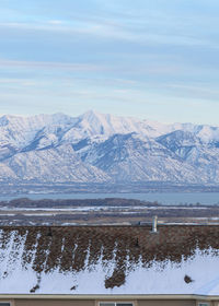 Scenic view of lake and snowcapped mountains against sky