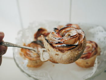 Close-up of hand holding food on spoon