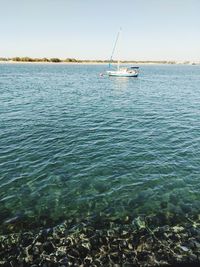 Sailboat in sea against sky