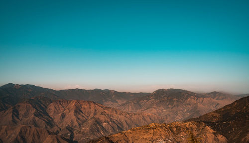 Scenic view of mountains against clear blue sky