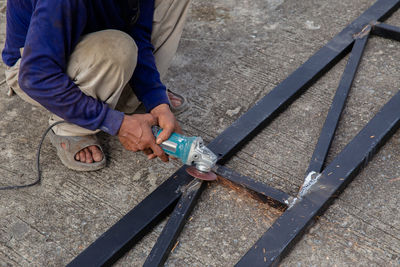 High angle view of man working on metal