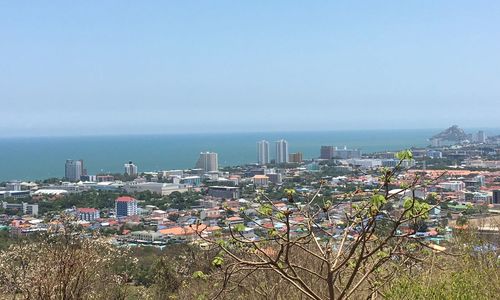 High angle view of buildings and sea against sky