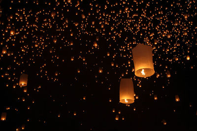 Low angle view of illuminated paper lanterns at night