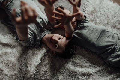 High angle view of baby lying on bed