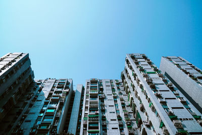 Low angle view of buildings against clear blue sky