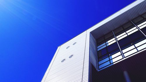 Low angle view of buildings against clear blue sky